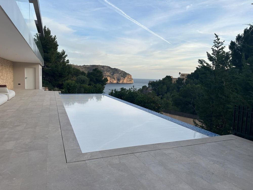 Cubierta automática cerrada en piscina infinita con vistas al mar